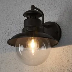 Lindby Außen-Wandleuchte Eddie - dimmbar, rustikales Design - Lampen für Außenbereich, dimmbar und ideal für eine stimmungsvolle Beleuchtung in Garten, Balkon oder Hauseingang. Hochwertiges Eisen und Glas in rostbraun und klar.