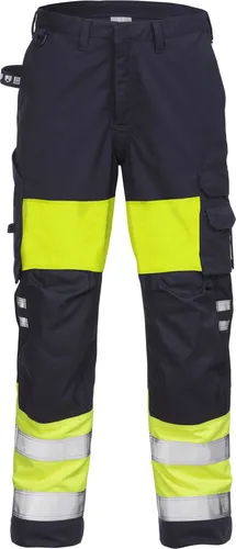 Fristads Flamestat High Vis Hose Damen Kl. 1 2776 ATHS - Warnschutz-Gelb/Marine - 50 - Zertifizierte Warnschutz-Hose mit Flammschutz, ideal für ATEX-Umgebungen. Femininer Schnitt, schmutz- und wasserabweisend, mit verstärkten Taschen und ergonomisch geformten Knien für optimalen Komfort bei der Arbeit.