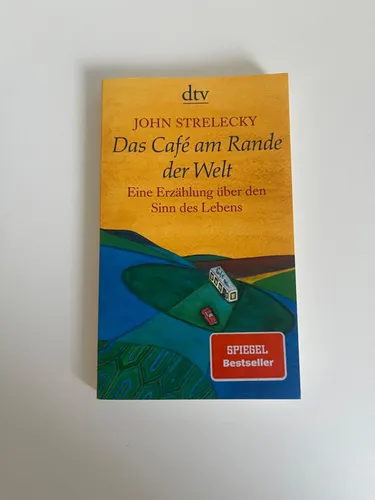 Das Café am Rande der Welt von John Strelecky - Inspirierendes Taschenbuch über Lebensfragen, 128 Seiten voller Weisheit, ideal für Selbstreflexion und persönliche Entwicklung.