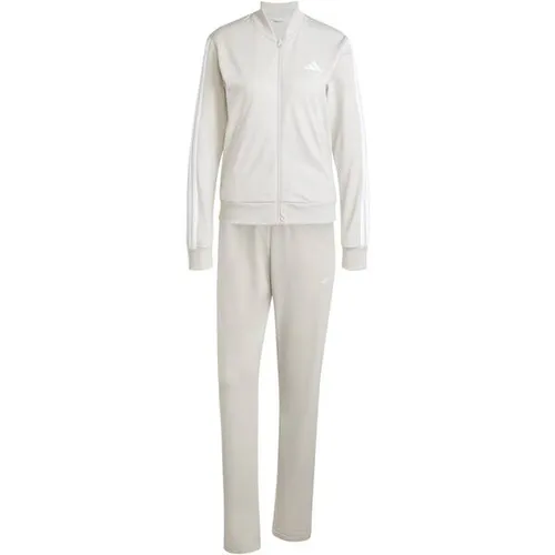 adidas Damen ESSENTIALS 3-STRIPES TRACKSUIT wonder alumina, S - Trainingsanzüge, regulär geschnitten mit elastischem Bund und Kordelzug für optimalen Tragekomfort, aus 100 % recyceltem Polyester hergestellt.