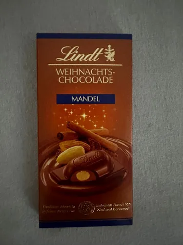 Lindt Weihnachts-Chocolade Mandel 100g - Leckere Weihnachts-Chocolade mit knackigen Mandeln, ideal für die festliche Zeit. Perfekt zum Verschenken oder für den eigenen Genuss.