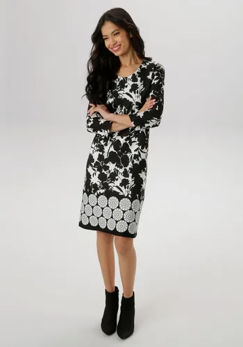 Jerseykleid mit floralem Druck - Aniston Selected, Gr. 38, schwarz-wollweiß - Elegantes Jerseykleid mit Rundhalsausschnitt und 3/4-Ärmeln aus elastischer Milano Rib-Ware. Auffälliger floraler Druck und dekoratives Muster am Saum machen jedes Kleid zum Unikat.