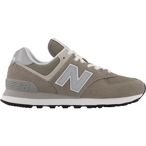 New Balance Damen 574 Sneaker, Grau Dark, 41 EU - Damen-Sneaker mit retro Ästhetik und modernstem Dämpfungssystem für optimalen Komfort. Ideal für Straßen- und Trail-Läufe, bietet eine individuelle Passform dank verstellbarem Schnürverschluss.