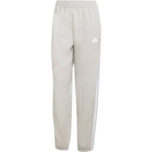 ADIDAS Damen Sporthose Train Essentials 3-Streifen Woven - Fitnesshosen mit CLIMACOOL-Technologie für effektives Feuchtigkeitsmanagement, aus 70 % recycelten Materialien für mehr Nachhaltigkeit und modernen, bequemen Tragekomfort.