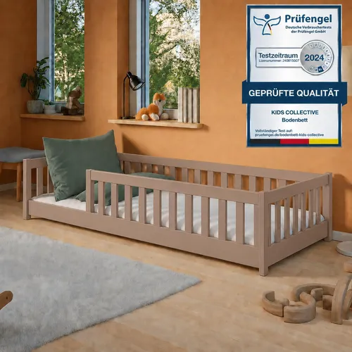 Montessori Kinderbett 90x200 cm mit Rausfallschutz in Milchschokolade - Das stilvolle Montessori Kinderbett sorgt für Sicherheit und Selbstständigkeit. Mit einer Matratzenfläche von 90x200 cm und stabilem Kiefernholz ist es ideal für lebhafte Kinder. Die niedrige Höhe ermöglicht einfaches Ein- und Aussteigen.