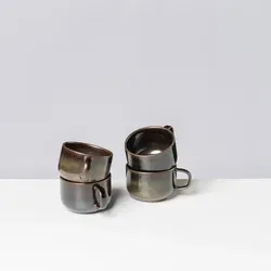 Gipfelstück Tasse Glockenklang aus Steinzeug - Thermobehälter mit seidenmattem Metallic-Look, inspiriert von traditioneller Glockengießerei, ideal für stilvolle Tischdekoration und Genuss.