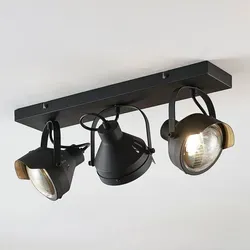 Lindby Strahler Henega, 3-flammig im industriellen Design - Baustrahler im klassischen Scheinwerfer-Stil mit schwarzem Metall und geriffeltem Glas, ideal für stimmungsvolle Beleuchtung in Wohnräumen.
