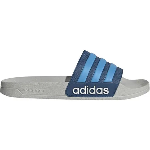 ADIDAS Herren Badeslipper Shower adilette - Die ADIDAS Shower adilette ist der perfekte Begleiter für Schwimmbad und Freizeit. Leicht und bequem, bietet sie optimalen Komfort und einen sportlichen Look mit dem ikonischen adidas Logo. Ideal für jeden Tag!