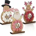 Produktbild: com-four® 3X Holz-Aufsteller für Weihnachten - Rentier, Weihnachtsmann und Schneemann aus Holz zum Hinstellen - Deko Holzfiguren Zierschmuck (Trio - Hellrosa/weiß/rosa)