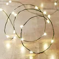 Produktbild: Lights4fun 50er LED Micro Lichterkette perlweiß auf grünem Draht Timer Batterie