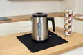 Produktbild: FireMat Feuerfeste Unterlage für Elektrogeräte wie Kaffeemaschinen, Mikrowelle, Wasskocher, Toaster Kochen auf Induktionsherd möglich. Black Edition (35x65cm)
