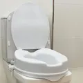 Produktbild: OrtoPrime Toilettensitzerhöhung 10cm mit Deckel Orthopädischer Toilettensitz mit seitlichen Sicherheitsverriegelungen - WC Sitzerhöhung für Senioren universeller Toilettenlift