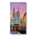 Produktbild: DEQORI Glasuhr | horizontal 30x60 cm | Motiv Kölner Wahrzeichen abends | große XXL Design Uhr aus Glas | leise Wanduhr für Wohnzimmer & Küche | moderne Hingucker Uhr für die Wand