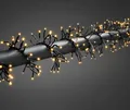 Produktbild: Konstsmide Micro LED Büschellichterkette Cluster, mit Multifunktion, frei wählbarem Timer und Dimmer, reagiert auf Musik, App-gesteuert (Android & IOS), 960 bernsteinfarbene Dioden, 36V_Außentrafo, schwarzes Kabel - 6563-870